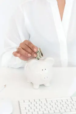 how to make money this week - woman putting money in a piggy bank